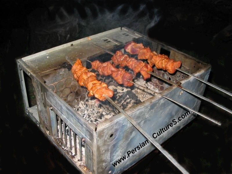 Roasting hot dogs over a computer.